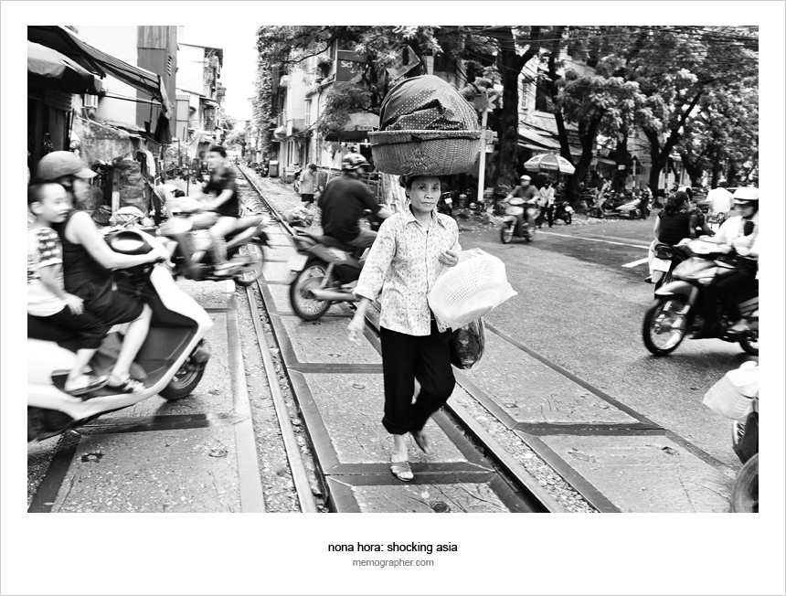 Woman crossing the traffic. Hanoi, Vietnam