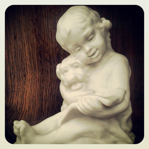 On My Shelves. A Porcelain Figurine of Girl and Dog reading Book