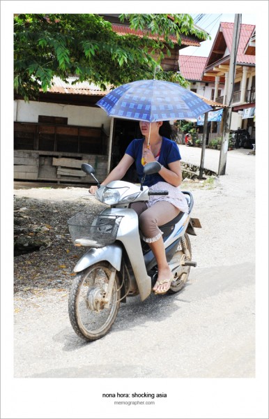 Lao Umbrella Girl on Scooter. Luang Prabang, Laos