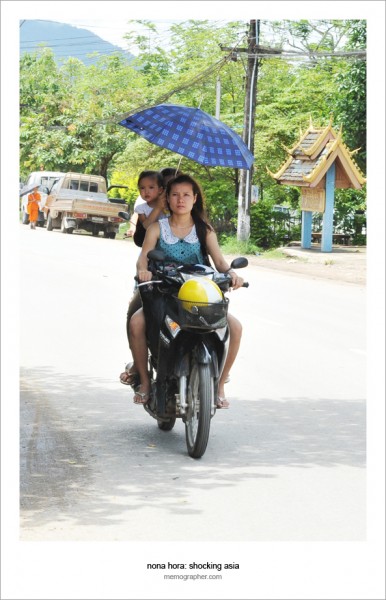 Lao Umbrella Girl on Scooter. Luang Prabang, Laos